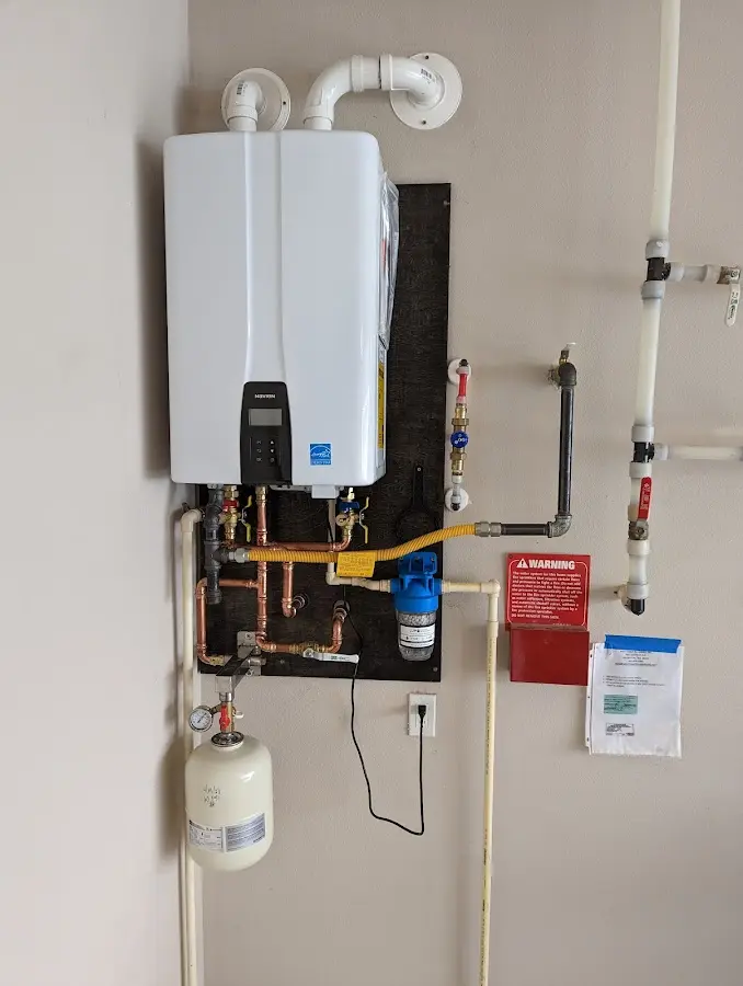 Professional plumber installing copper piping in a Ojus home